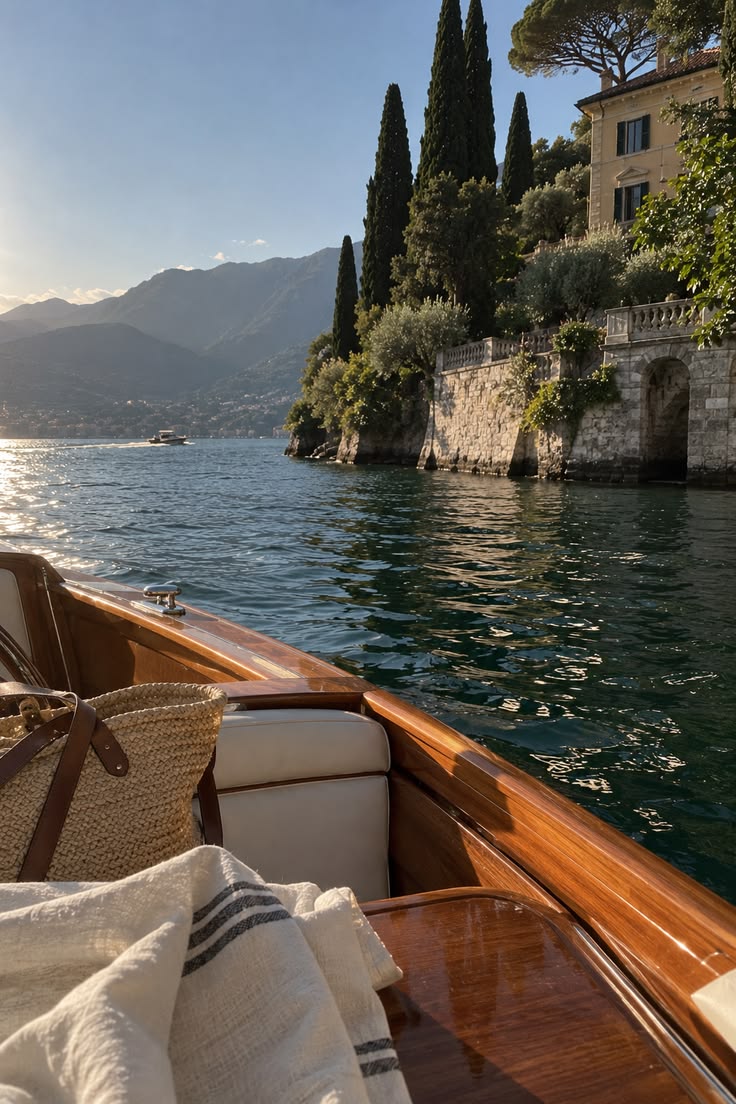 View from a wooden boat passing a lakeside villa