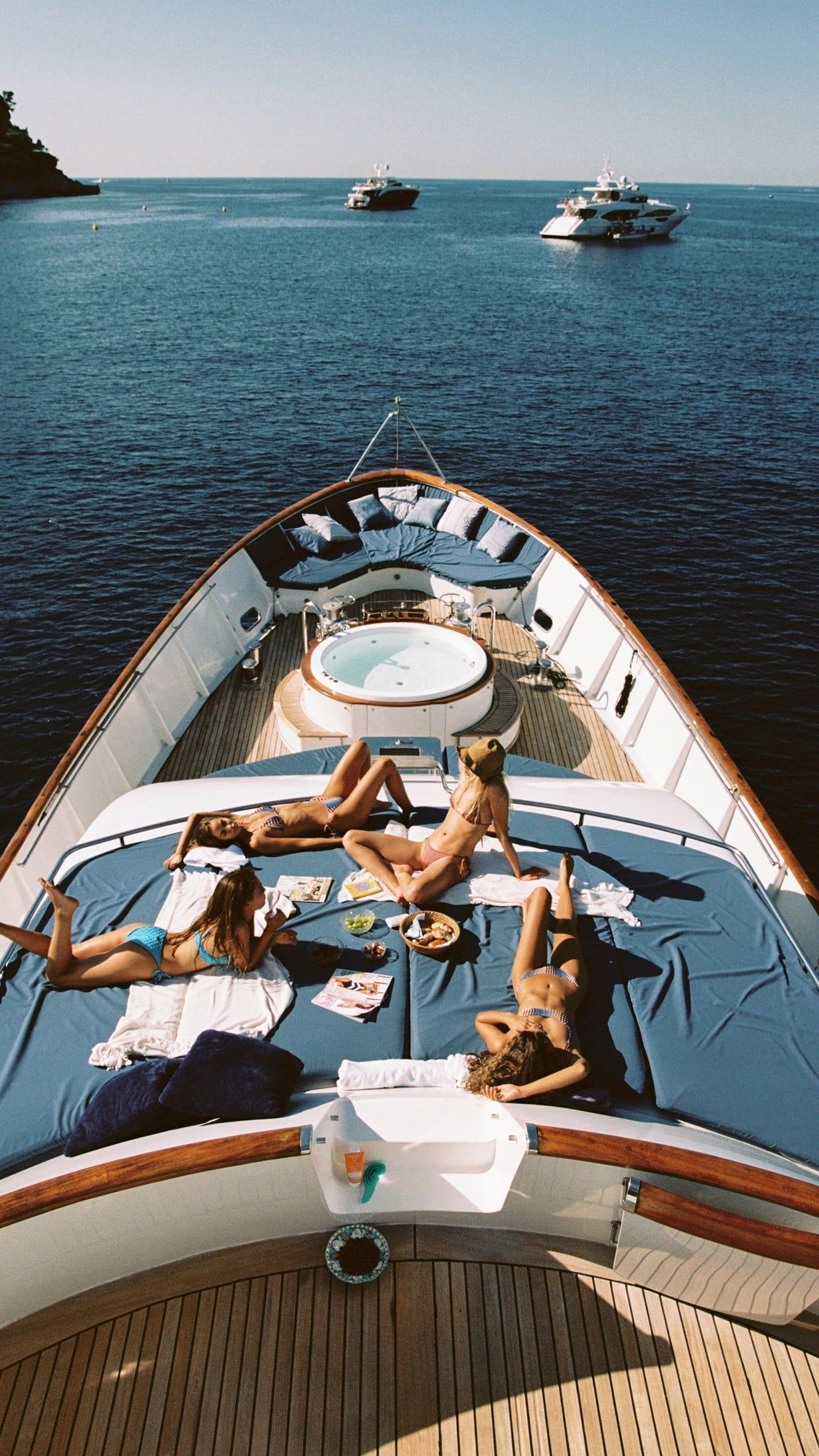 Guests resting on the sun deck of a yacht at sea